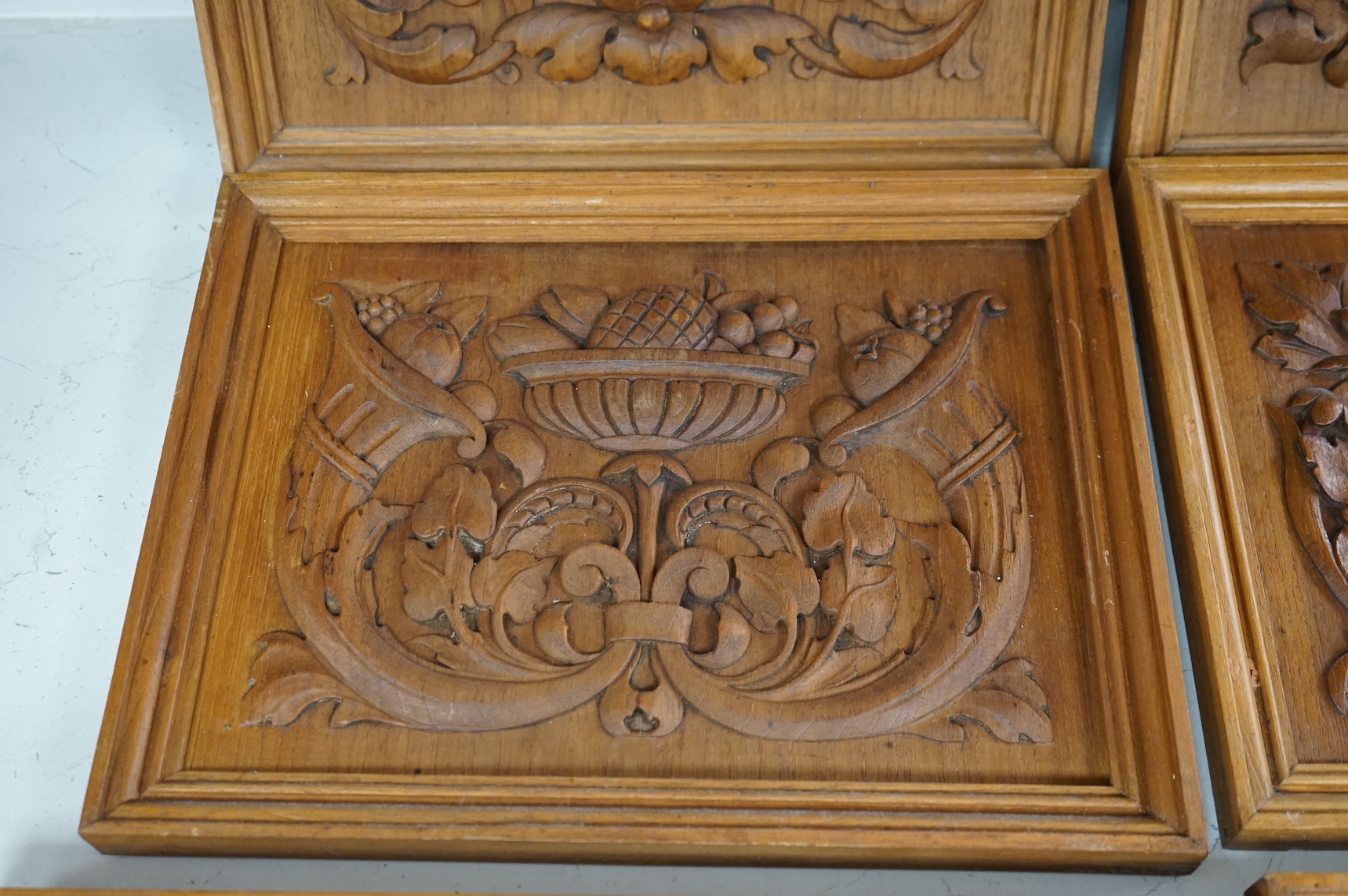 Six carved wood relief plaques, largest 31x46cm